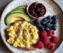 Colorful Breakfast Plate with Scrambled Eggs, Avocado, PB&J Toast & Fresh Berries