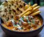 Creamy Butter Chicken with Garlic Drizzle, Fries & Warm Naan